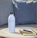 SMEG Clima Bottle Pastel Blue 500 ml lifestyle image with coffee and desk setup